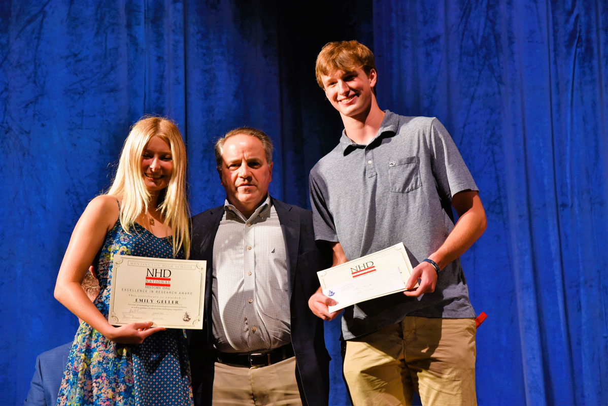 Award recipients Emily Geller and Chris Maichin flank department chair Joe Leavy