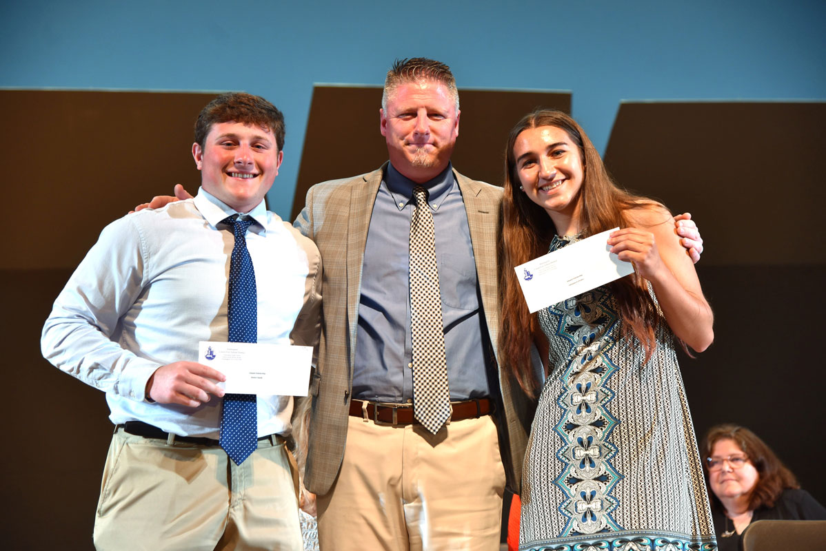 Principal Brenden Cusack with alumni scholarship recipients Robbie Smith and Adrianna LoScalzo