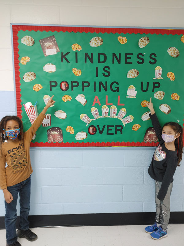 Washington students at a special kindness themed bulletin board.