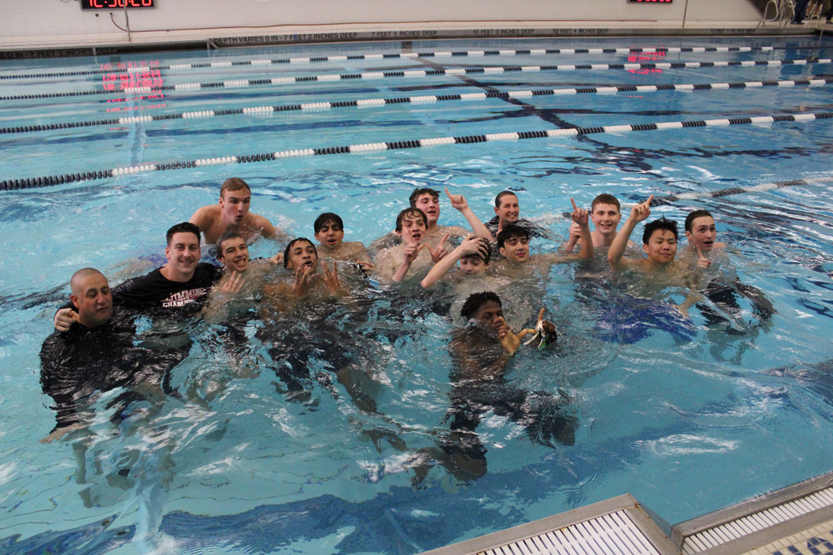 The Huntington-Harborfields-Walt Whitman swimming and diving team in the pool at the county championships.