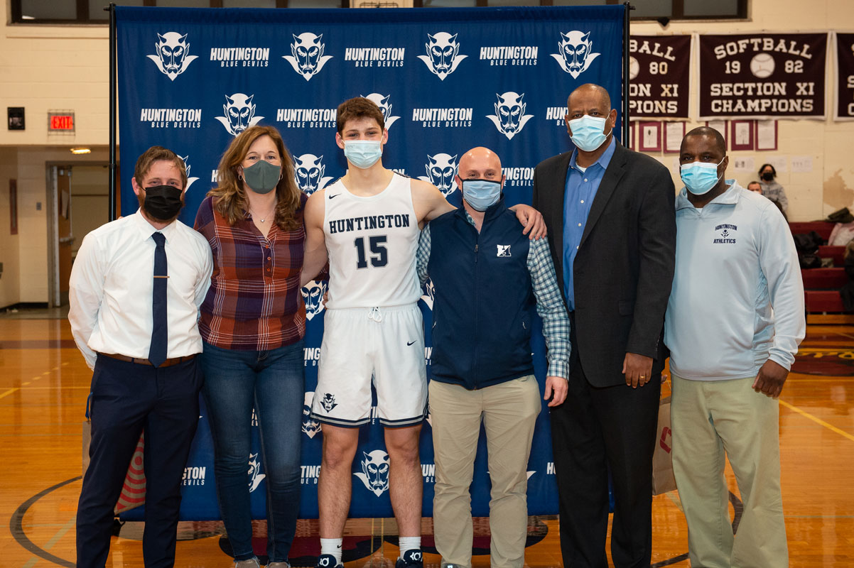 Charlie Girimonti with his parents and coaches on Senior Day. (Darin Reed photo.)