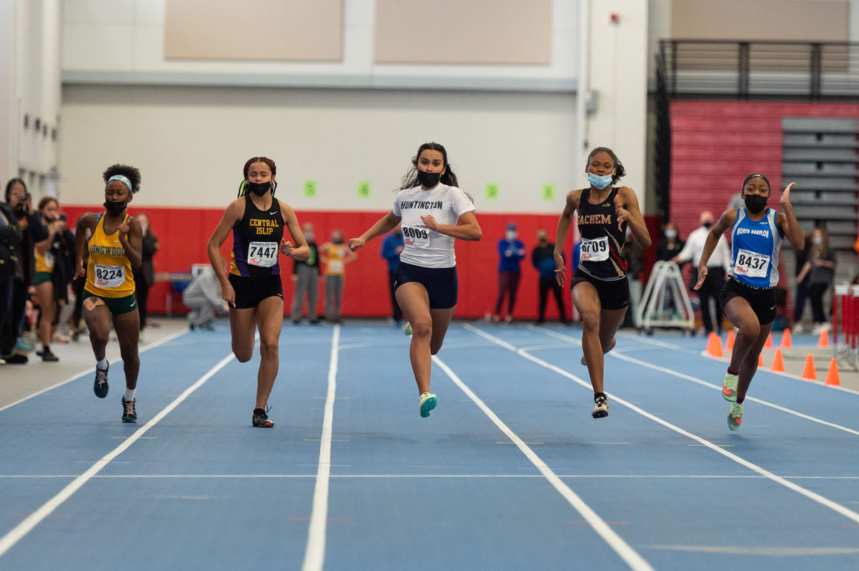 Olivia Conte (in white) races to the 55m dash finish line. (Darin Reed photo)