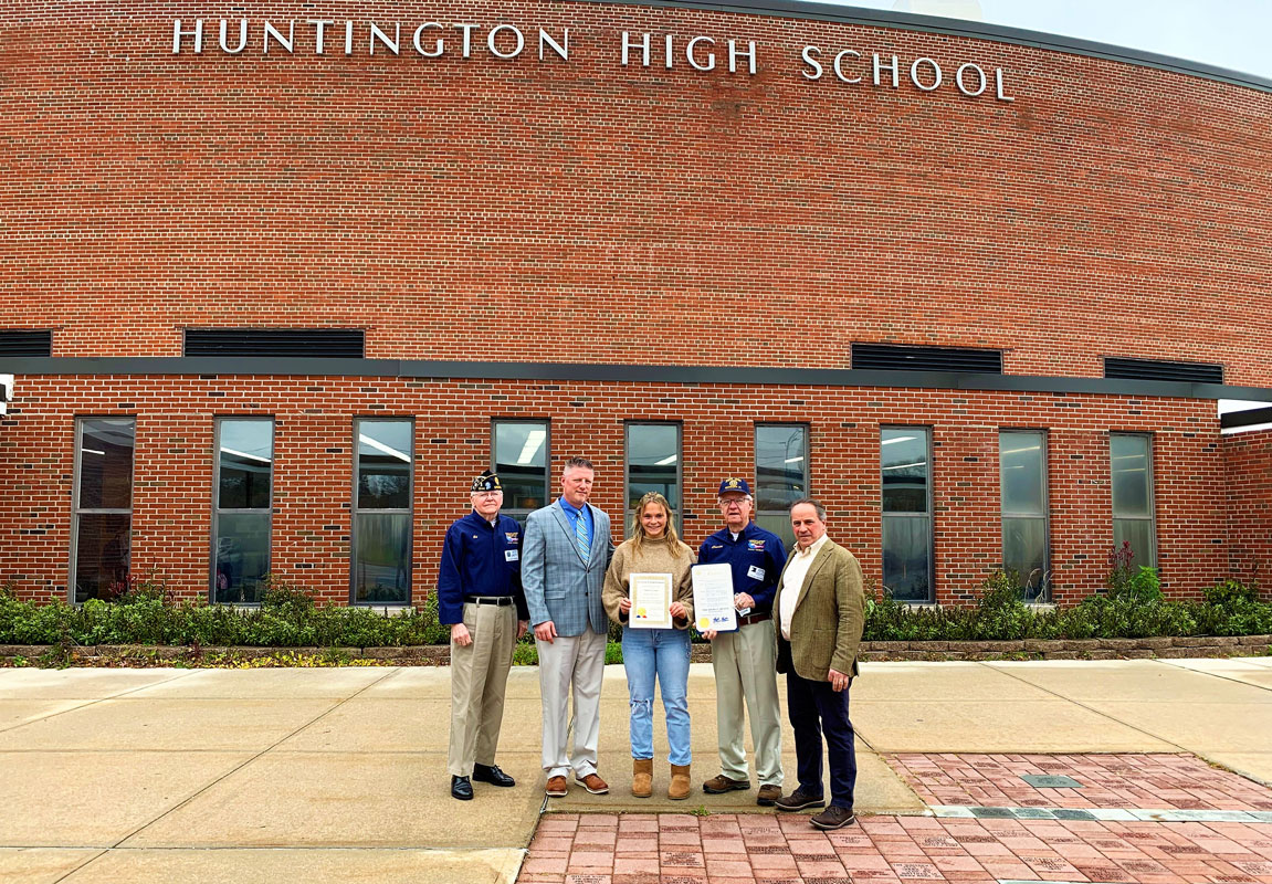 Teddi Carnesi surrounded by school and American Legion officials. 