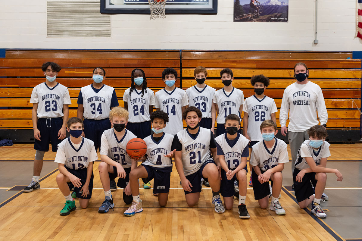 Coach Tim Madden with Finley boys' basketball players. (Darin Reed photo.)