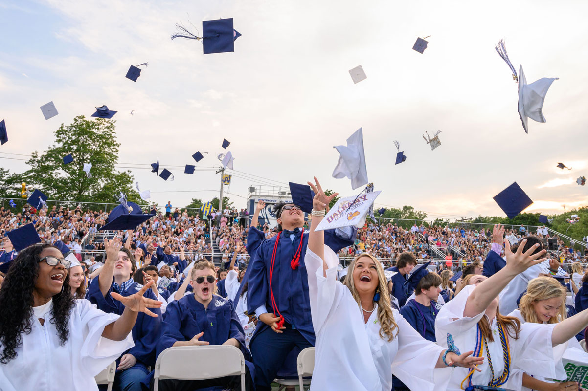 Newly minted Huntington alums toss their commencement caps in the air at June Commencement. (Darin Reed photo.)