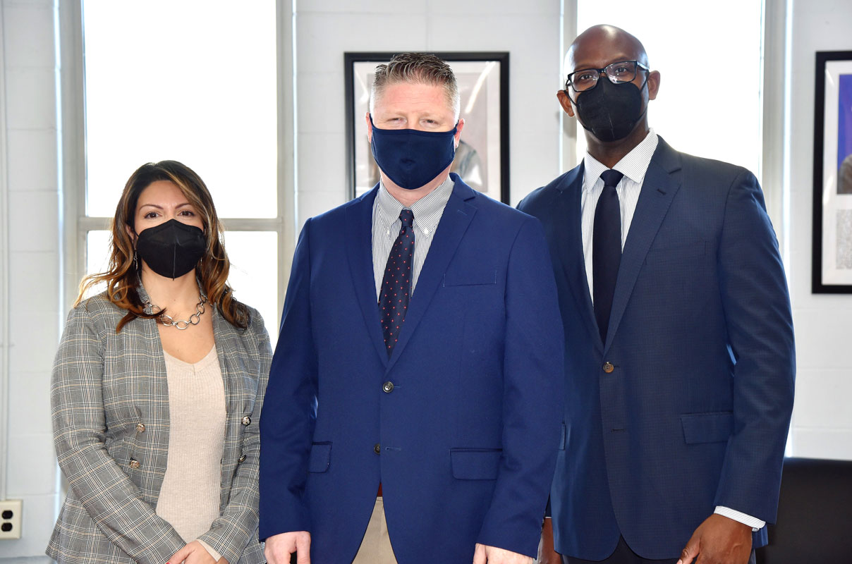 Princpal Brenden Cusack flanked by assistants Jully Williams and Gamal Smith.