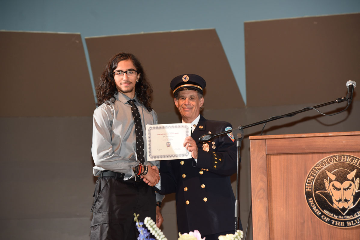 Howard Munson scholarship recipient Michael Mesen with Chief Neil Getter. 