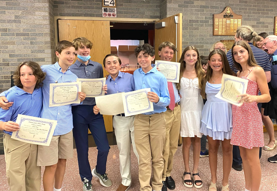 The teenagers were proud after their induction into the Junior National Honor Society 