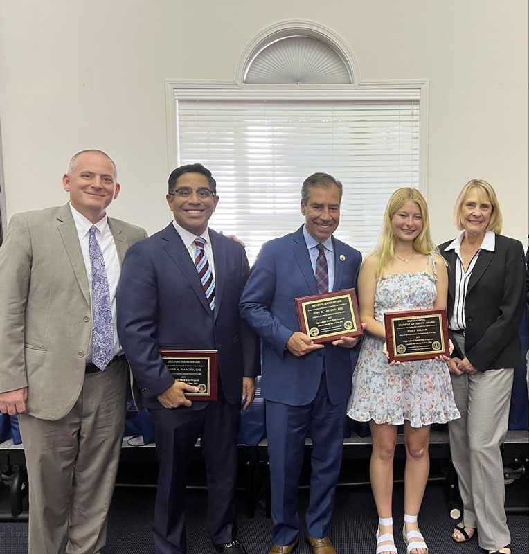Emily Geller, Xavier Palacios and John LoTurco hold awards while flanked by Suffolk Bar Assn. officials.