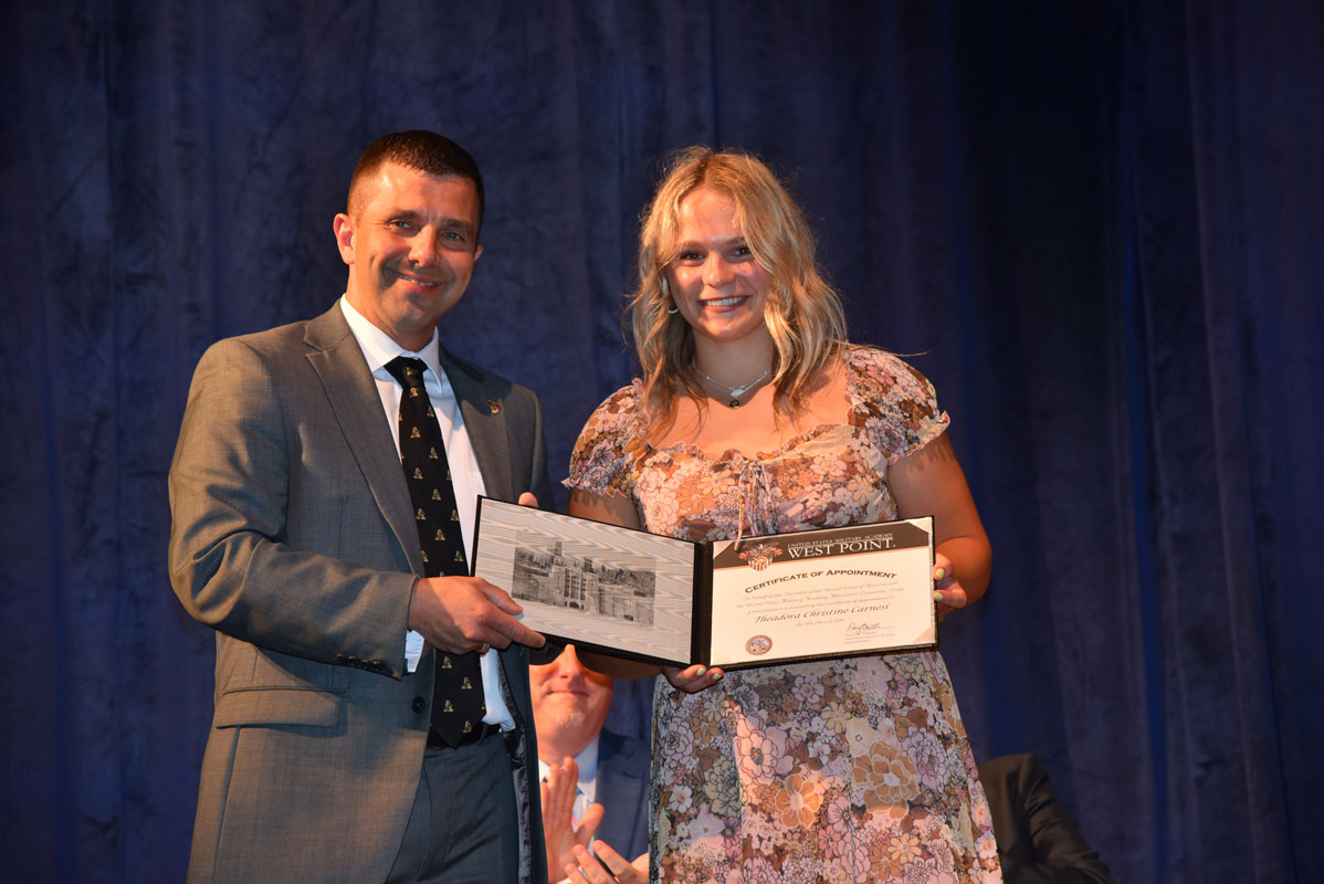 Gregory Kies presentes Theadora Carnesi with a Certificate of Appointment to the US Military Academy at West Point.