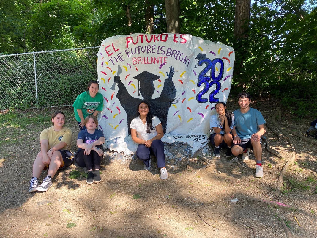 Teacher Jenna Rinaldi with five talented senior artists that painted The Rock.