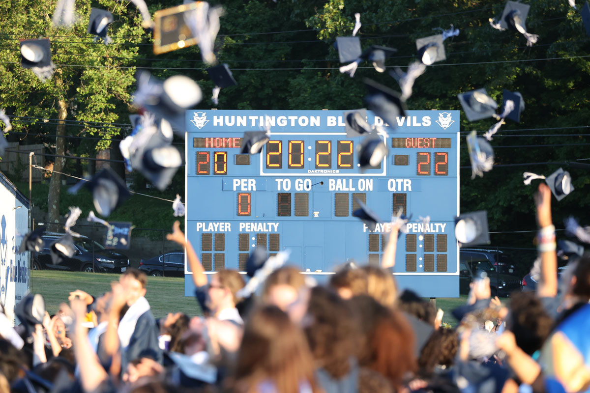 Huntington's Class of 2022 tosses its caps high into the air. (Craig Haas photo)