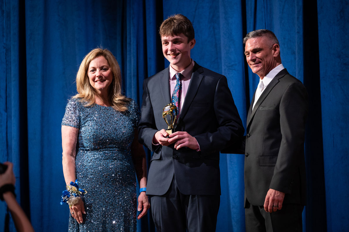 Huntington sophomore Jack Semelsberger with Town Council members Joan Cergol and David Bennardo.