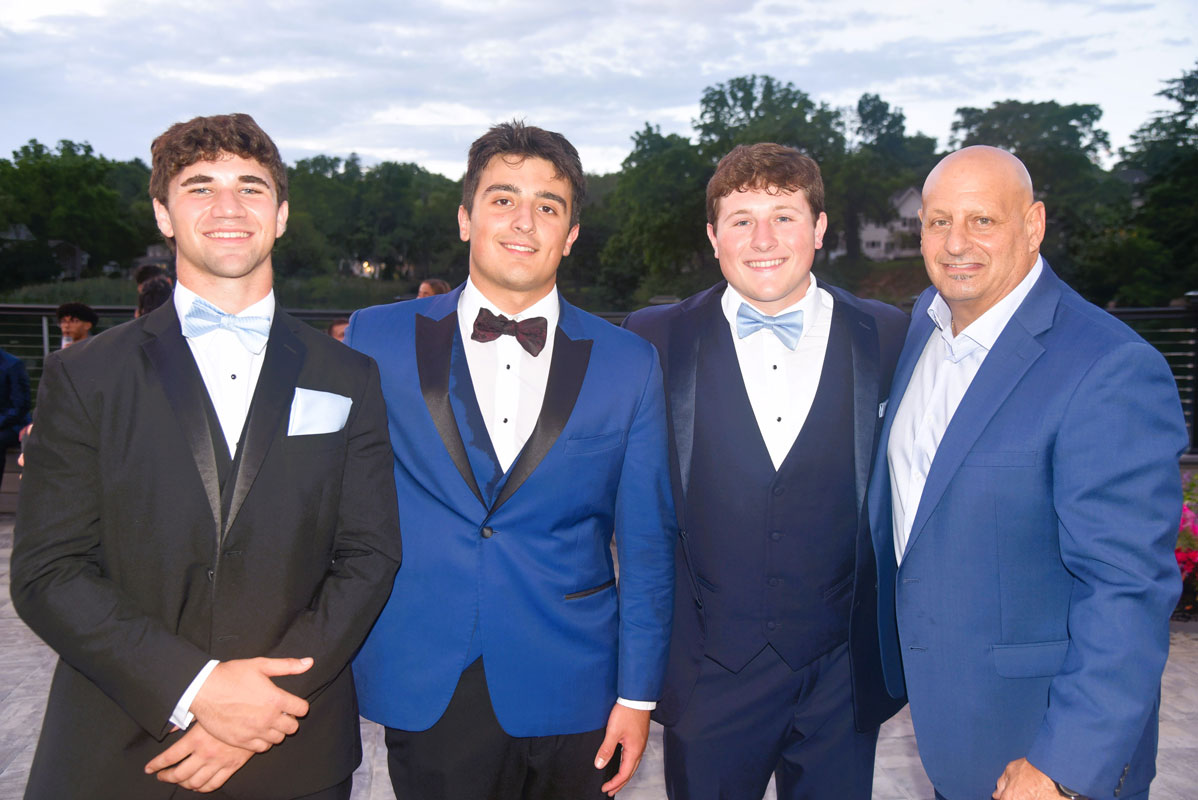Seniors Lucas Petrizzi, John Marziliano and Robbie Smith with Blue Devil football coach Steven Muller.