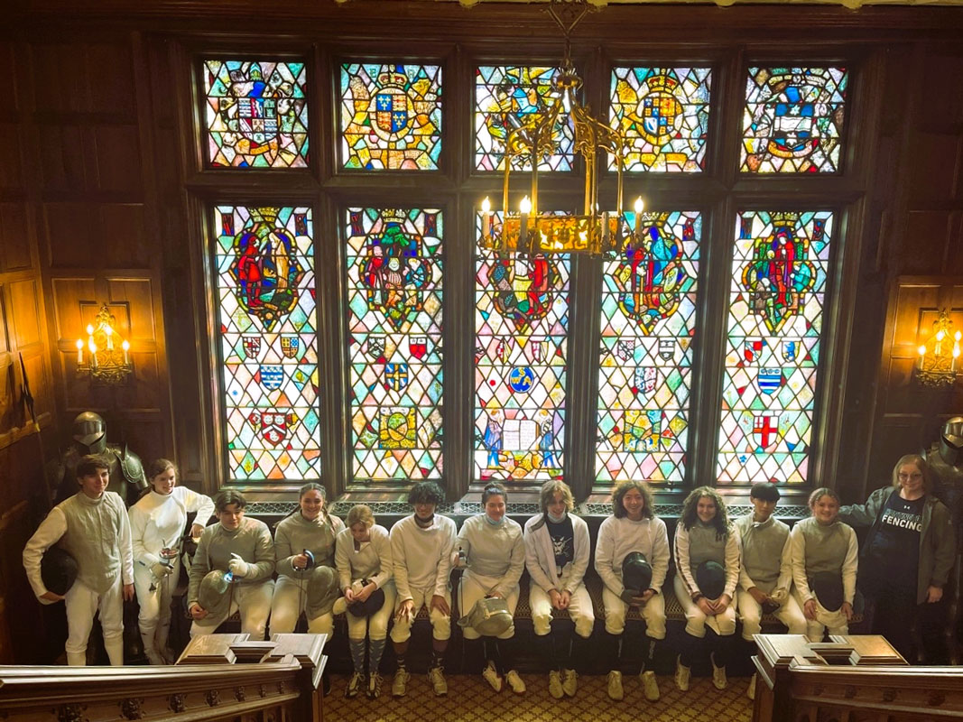 The five stained glass windows behind the Blue Devils feature different stories of William Shakespeare.