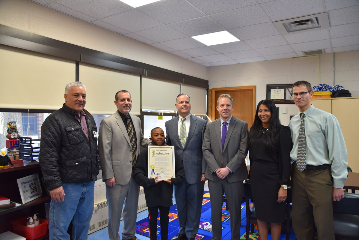 Cameron Batts with Supervisor Ed Smith with town and school officials and teachers.