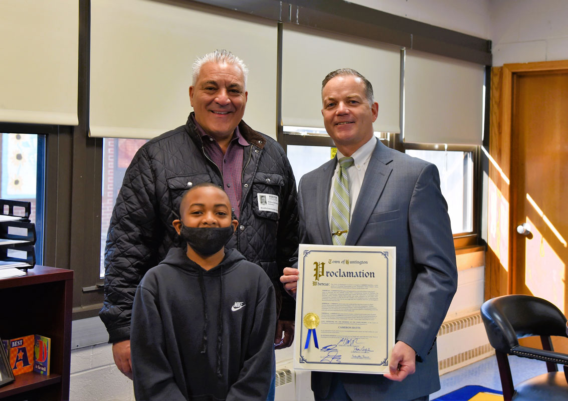 Town Supervisor Ed Smith and Highway Superintendent Andre Sorrentino presented Cameron Batts with a proclamation.