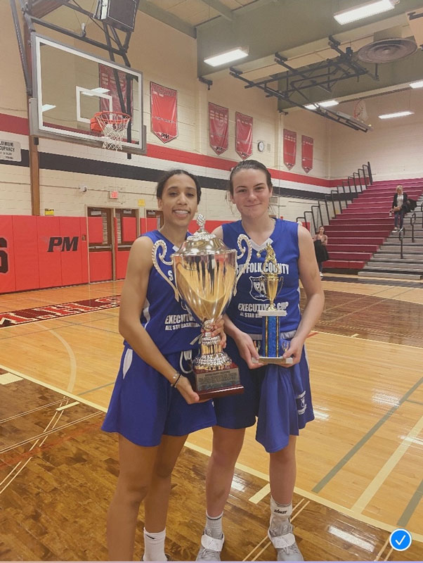  Makaylah Frazier holds the championship trophy and Emily Plachta has the MVP Award. 