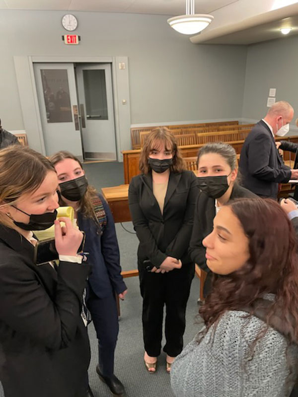 The Blue Devils compare notes in the courtroom.