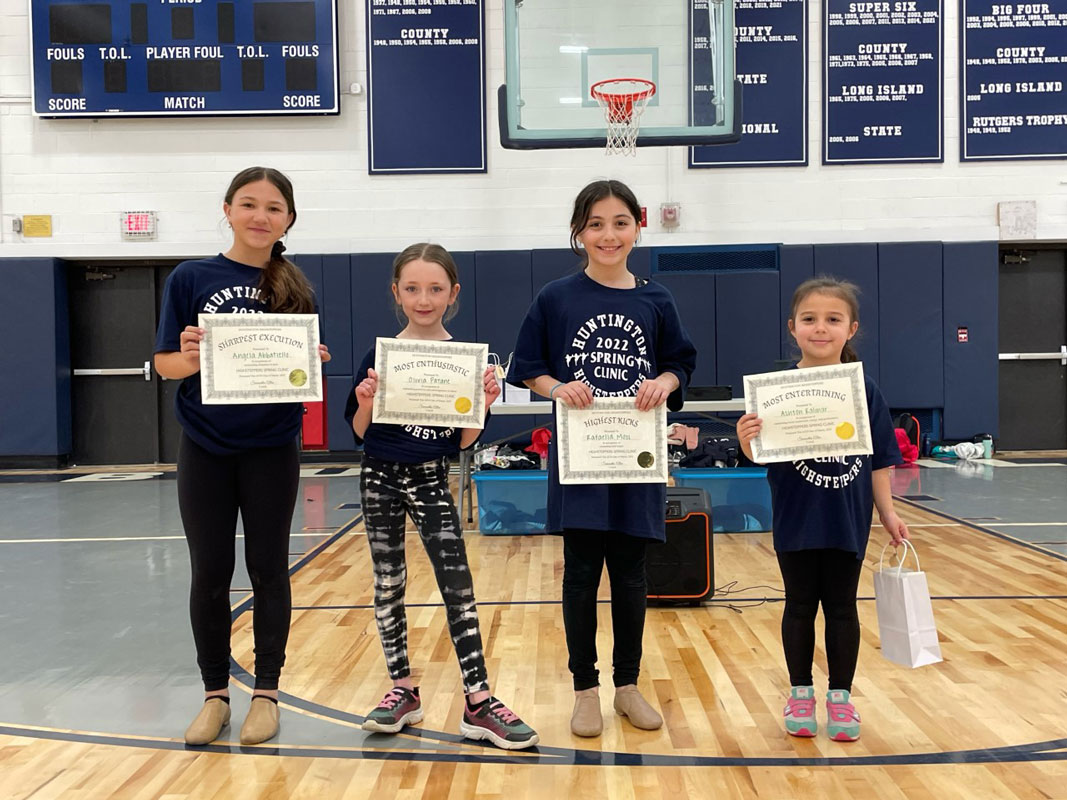 A group of proud award winners hold their certificates.