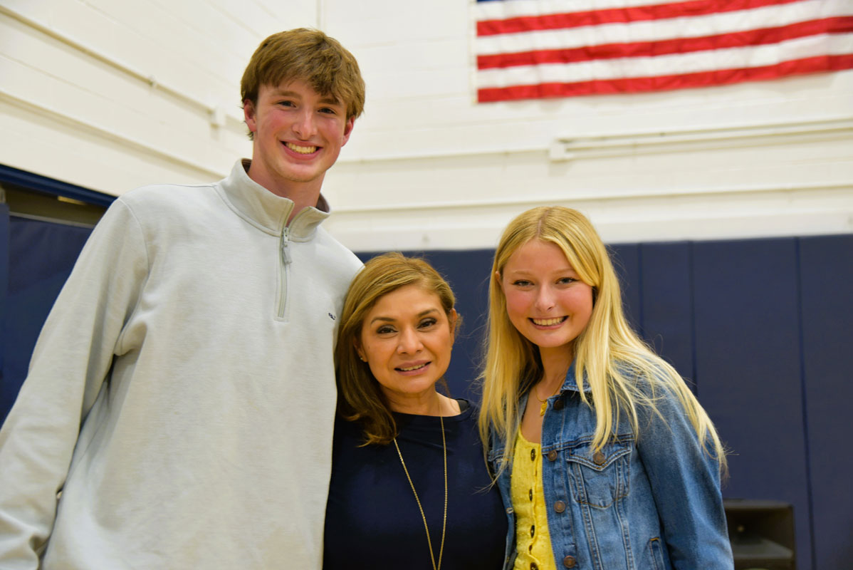 Chris Maichin and Emily Geller flank honored teacher Ingrid Moreira 