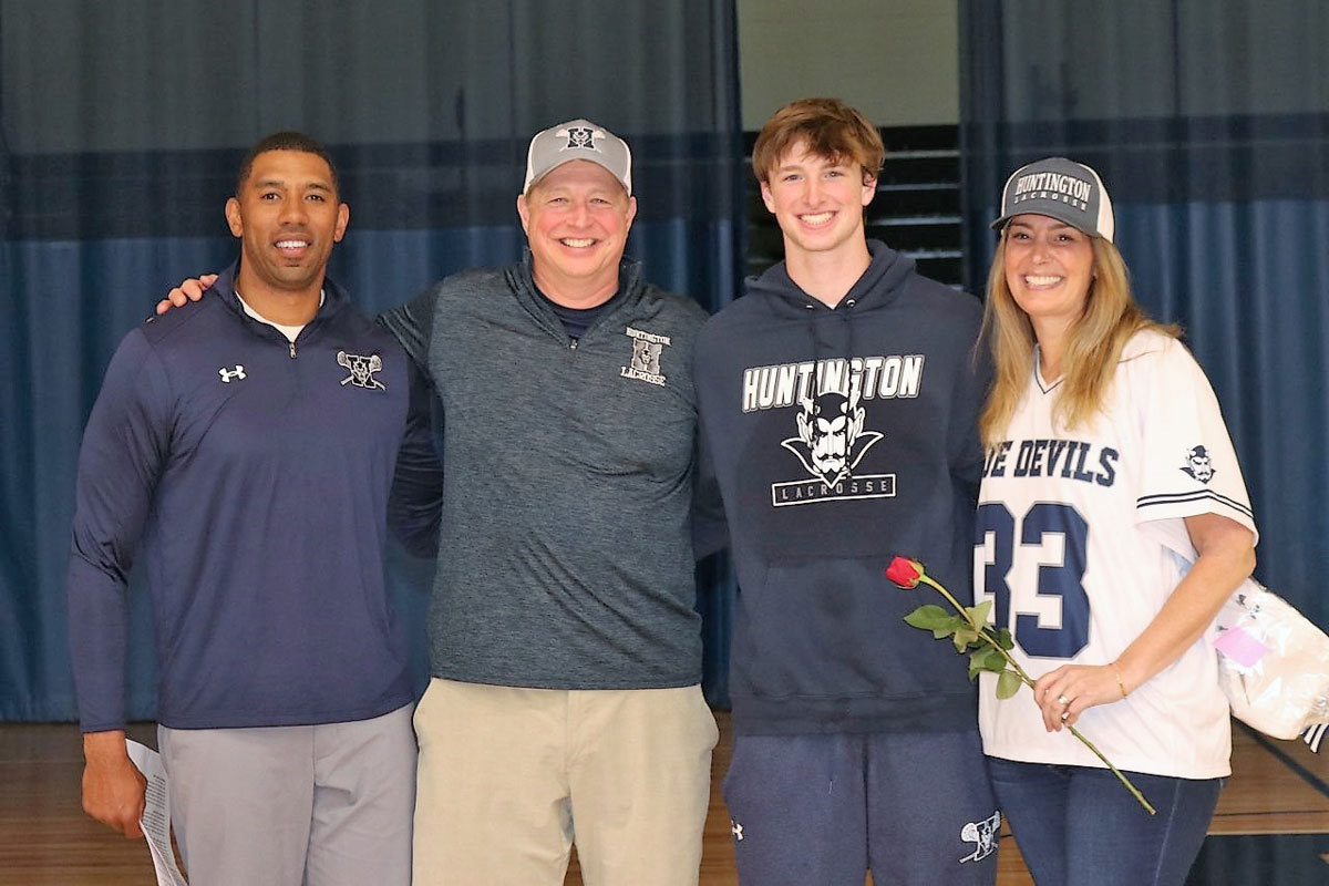 Senior Chris Maichin with his parents Rob and Jennifer and Huntington head coach Julian Watts.