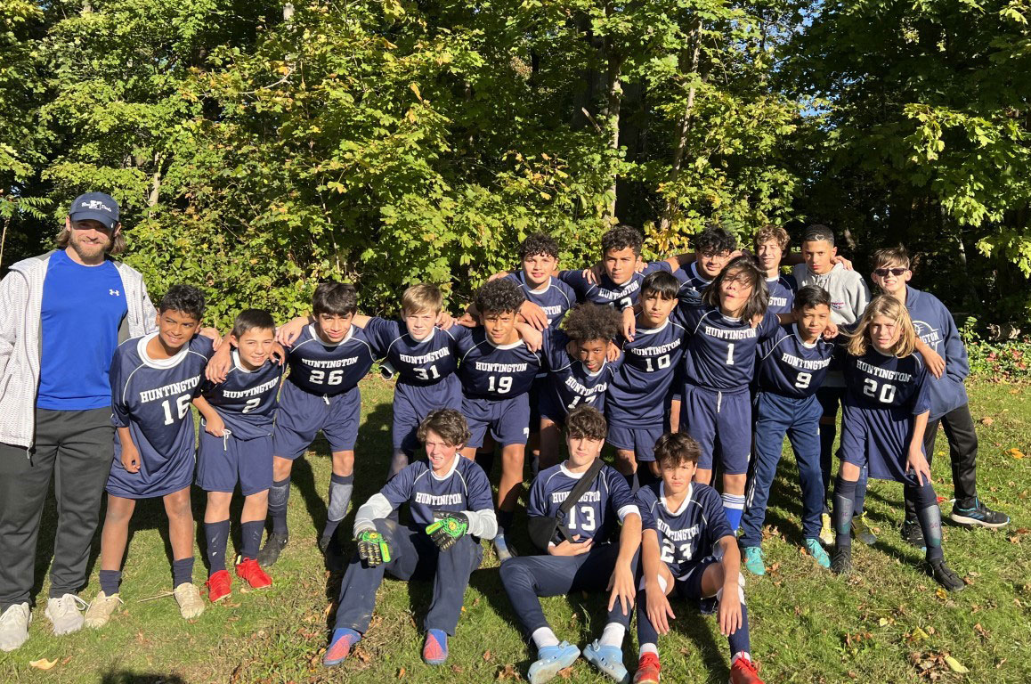 Coach Alex Nelson and the Finley-Blue boys' soccer team.
