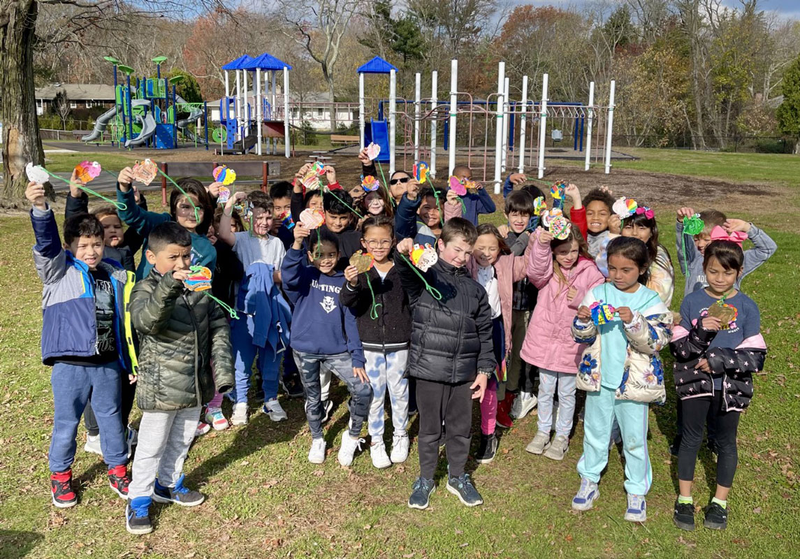 Jefferson physical education show their punched turkey necklaces after the turkey trot.