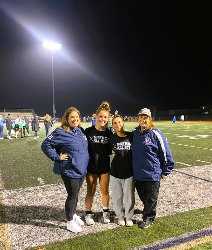 Laurel Bonn and Carlee Schultz are flanked by Huntington coaches Allison Conlon and Kathy Wright.