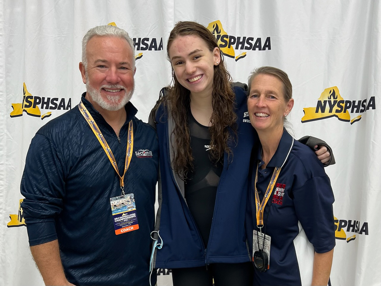  All-State swimmer Kathryn Montefusco with coaches Chris Helmke and Meg McConnell.  