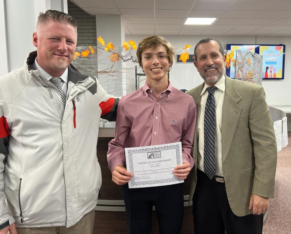 Social Studies Honor Society member Aidan Geller with Principal Brenden Cusask and Supt. Jim Polansky.