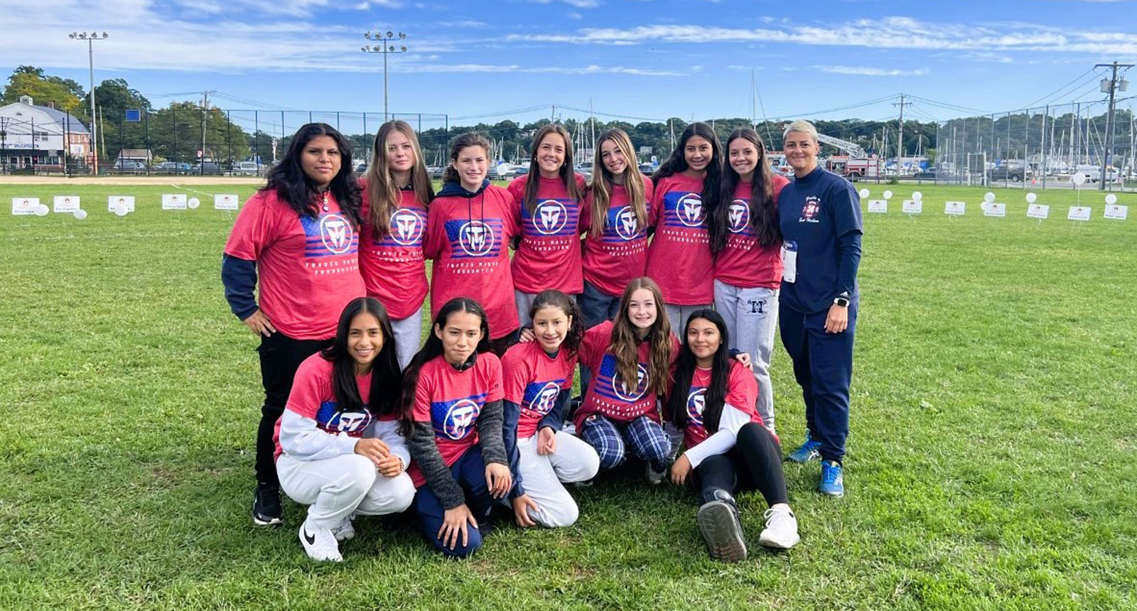 Huntington JV girls' soccer players and Maria Canino at the 9-11 run. 