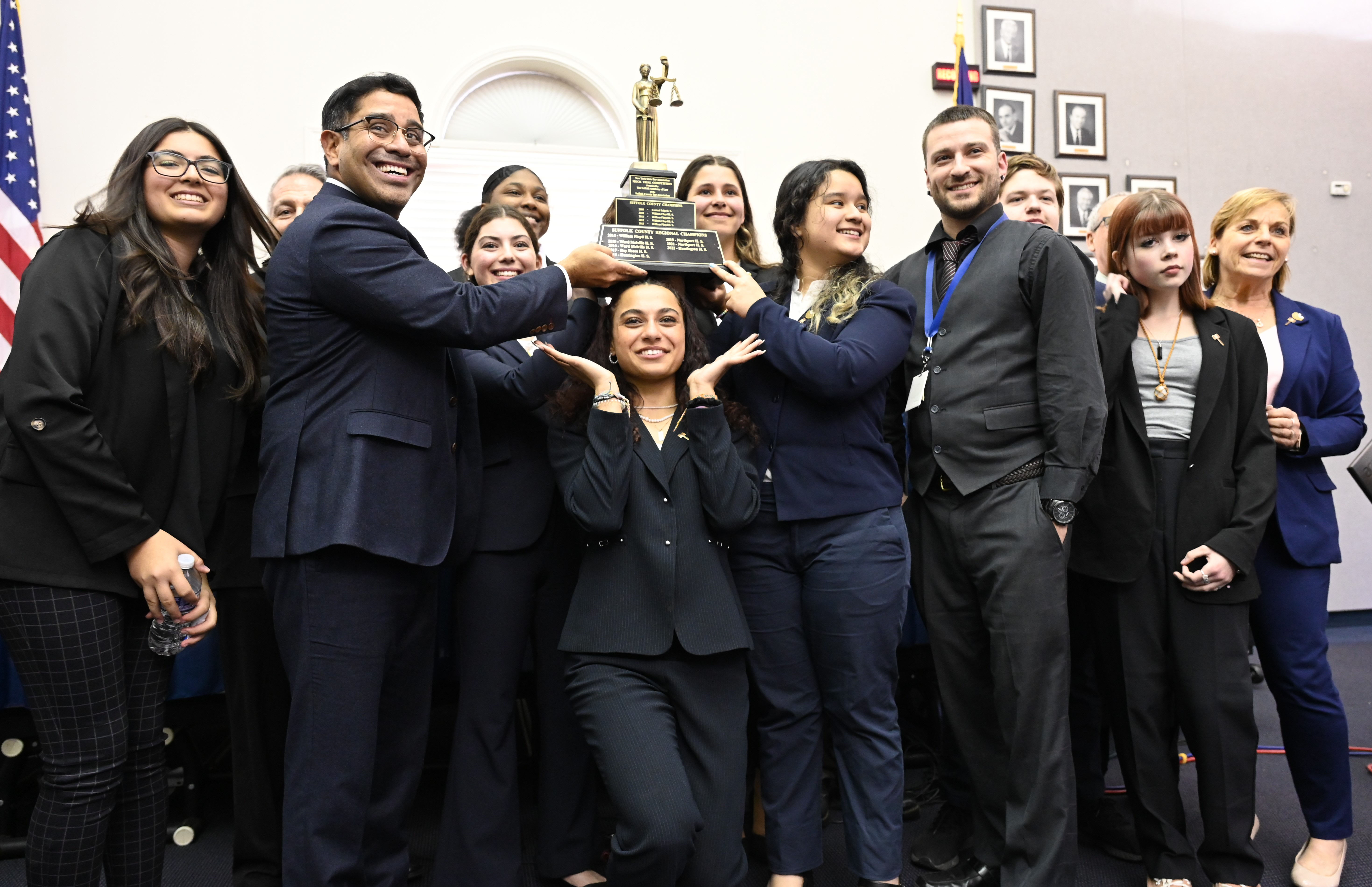 Huntington mock trial team members hold the county championship trophy after edging Northport in the finals.   