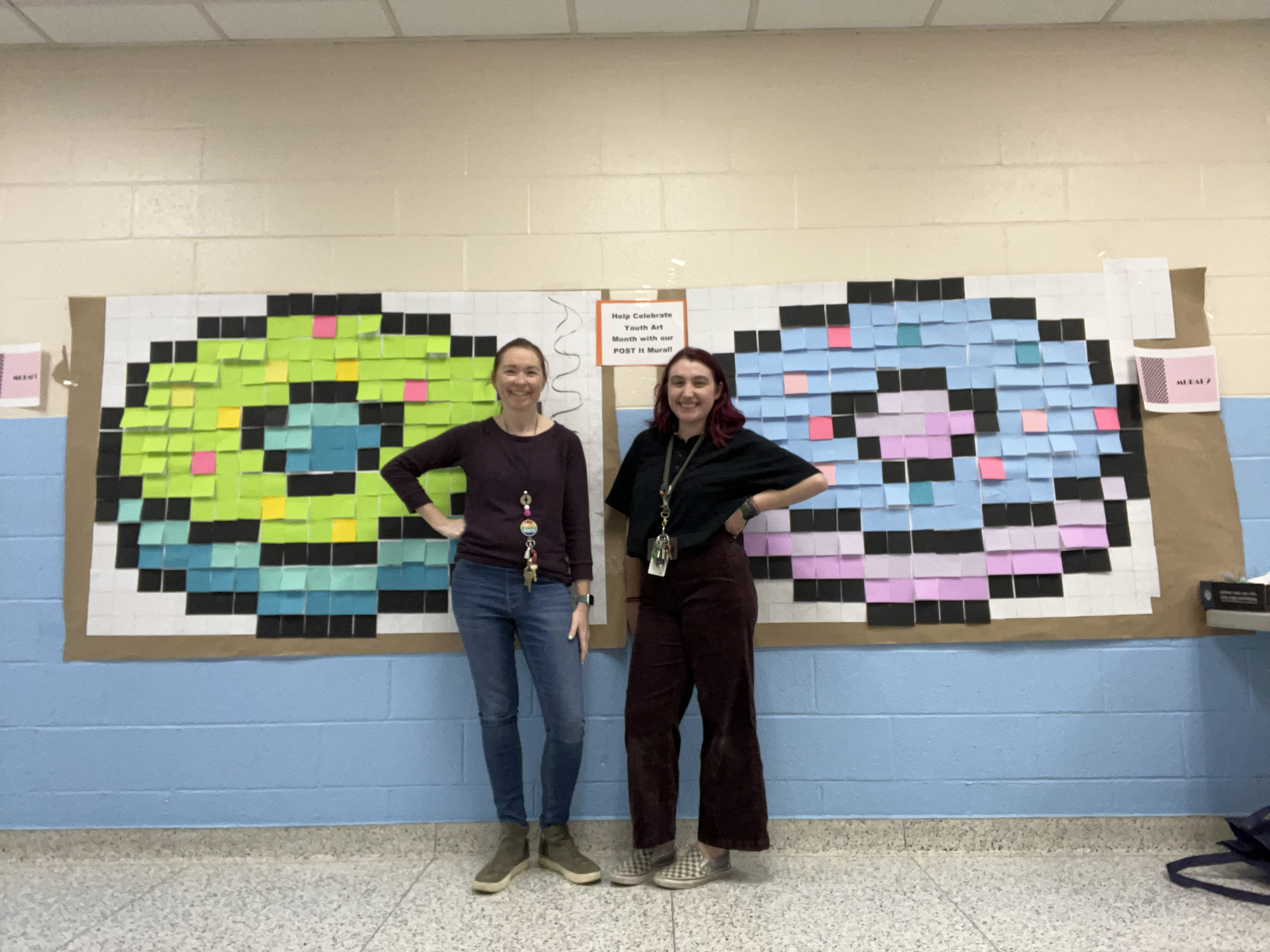  Finley art teachers Jessica Simms and Karen Morea stand near the Post-it murals.  
