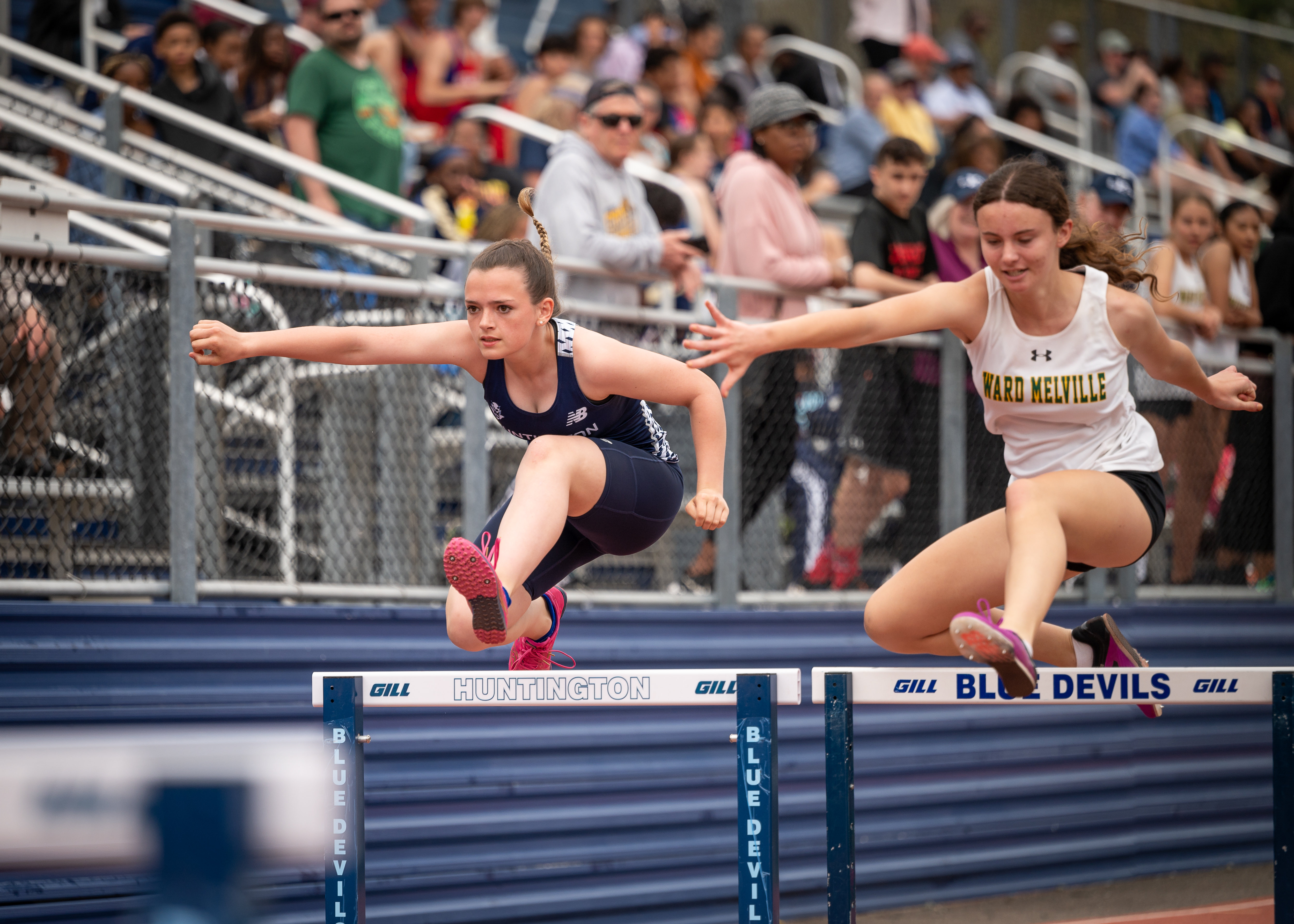 Freshman Dana Saramago keeps pace in the hurdles. (Darin Reed photo.)