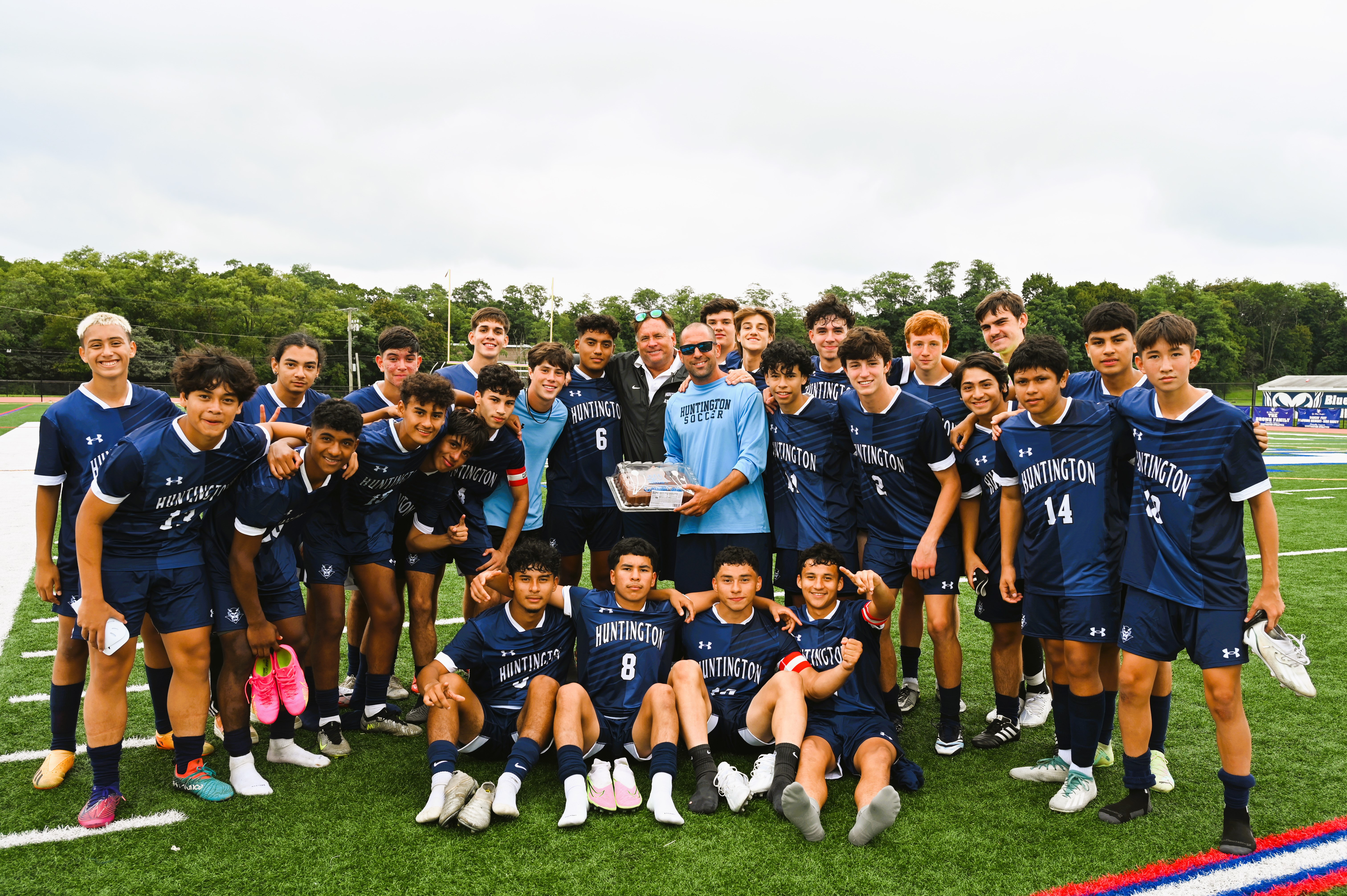  The Huntington boys' soccer team huddles around head coach John Pagano on the occasion of his 200th win. (Darin Reed photo.)  