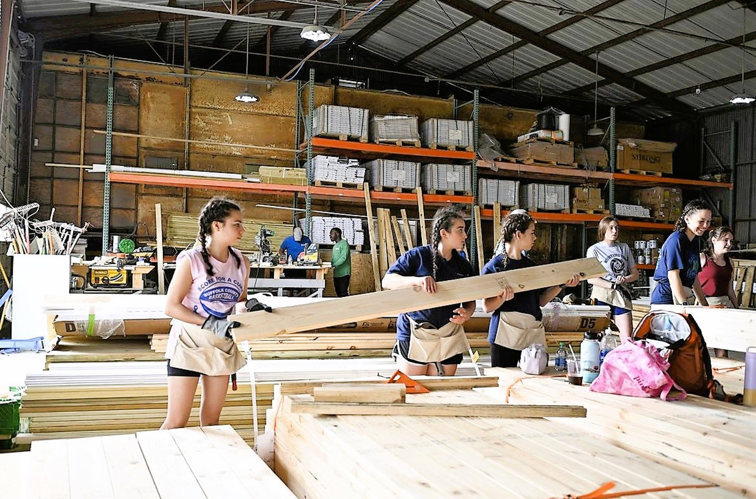  The Huntington Habitat club members worked hard to construct various sections of a house   