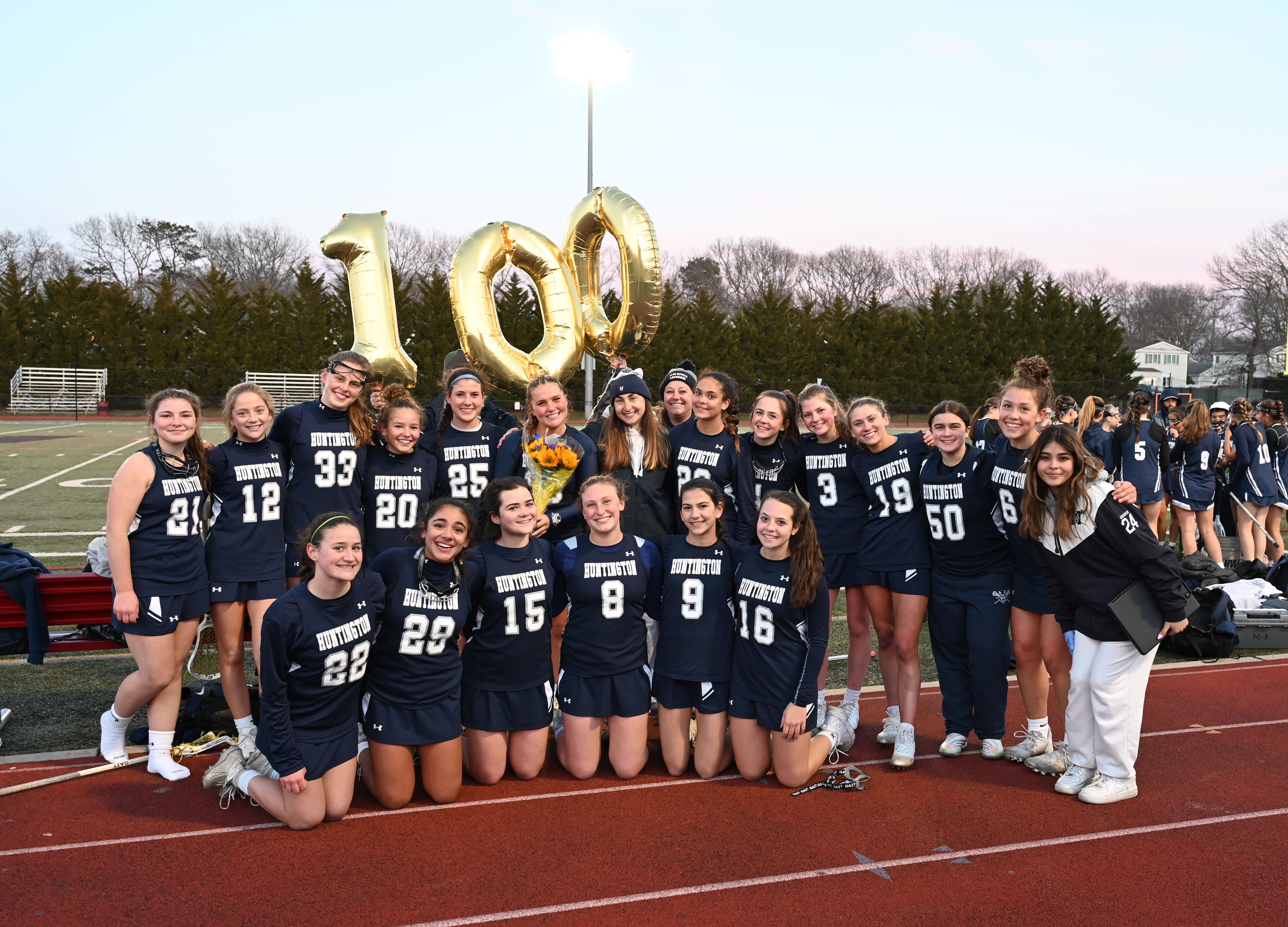  Gianna Forte (holding flowers) with her teammates after scoring her 100th point for Huntington.  