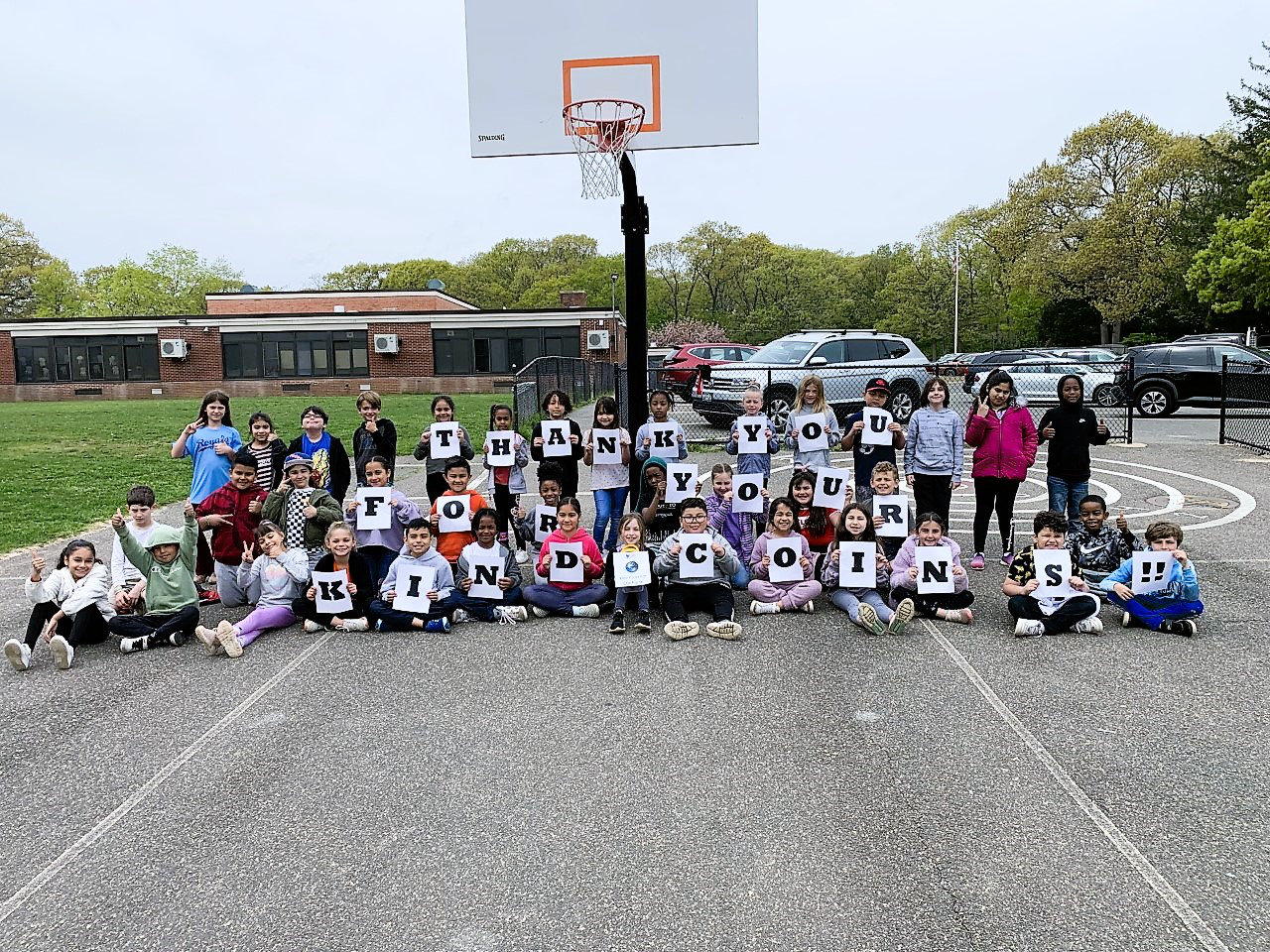 Flower Hill students thank the community for donating coins to its charitable drive.  