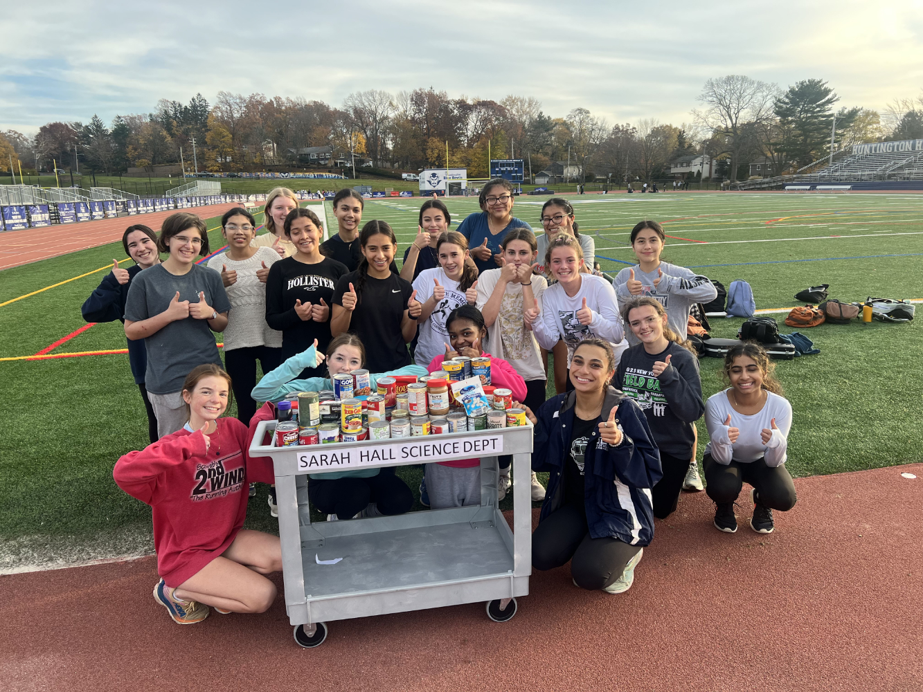  Blue Devil girls track team members with some of the collected food items.  