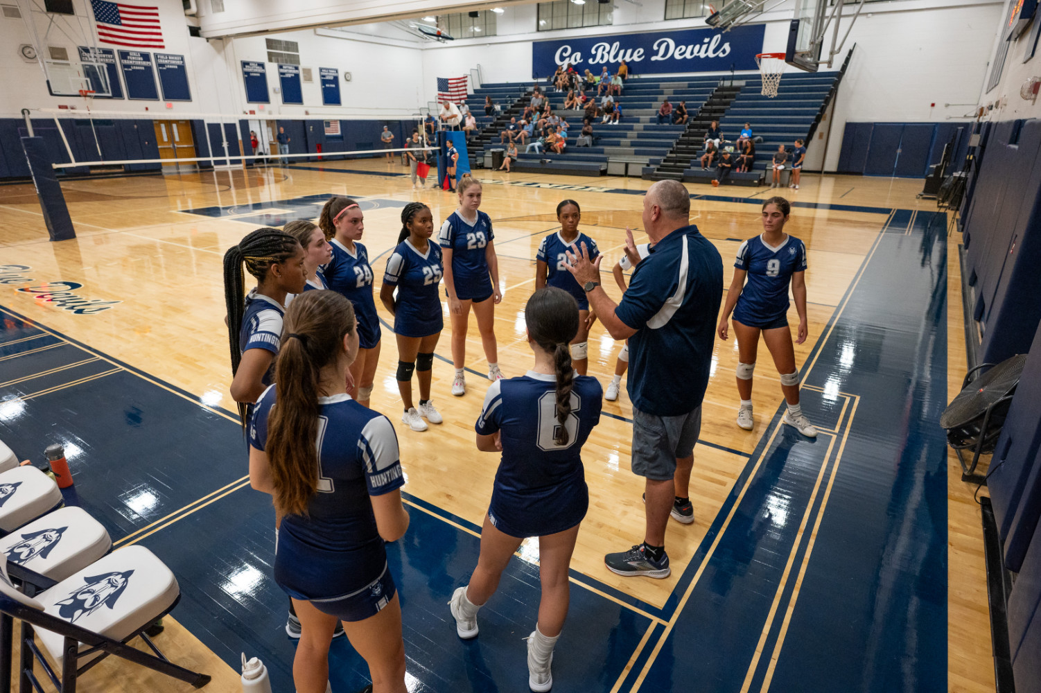  The Blue Devils huddle with head coach Todd Donaghy. (Darin Reed photo.)  