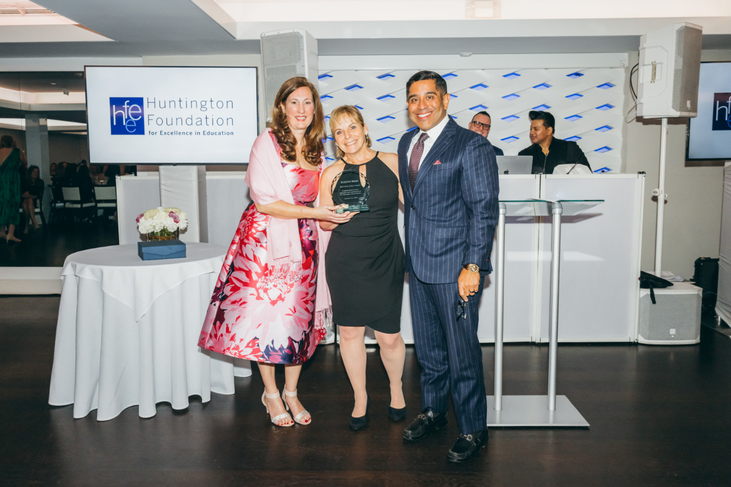  HFEE President Jennifer Stevens and School Board President Xavier Palacios flank Suzi Biagi.  