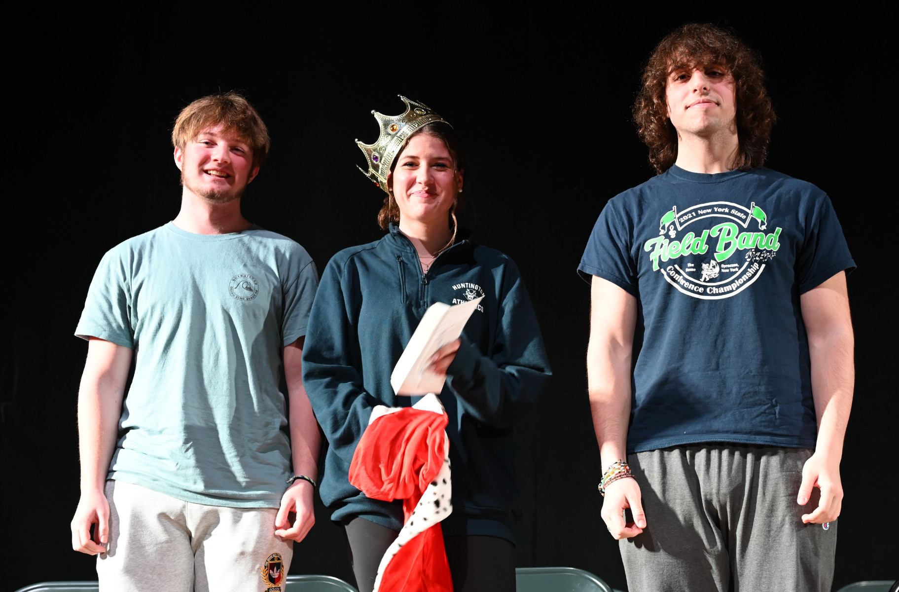  2023 spelling bee champion Devon St. John is flanked by finalists Ryan Curran and Peter Gaal.  