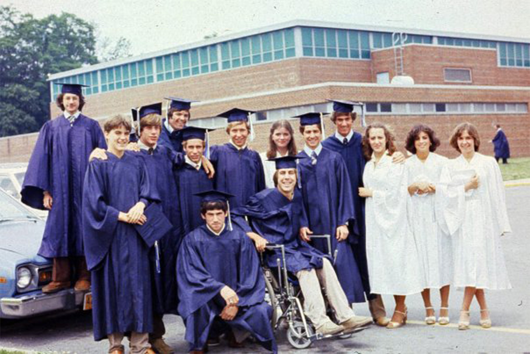  Peter Steen in his wheelchair surrounded by fellow graduates in June 1979.  
