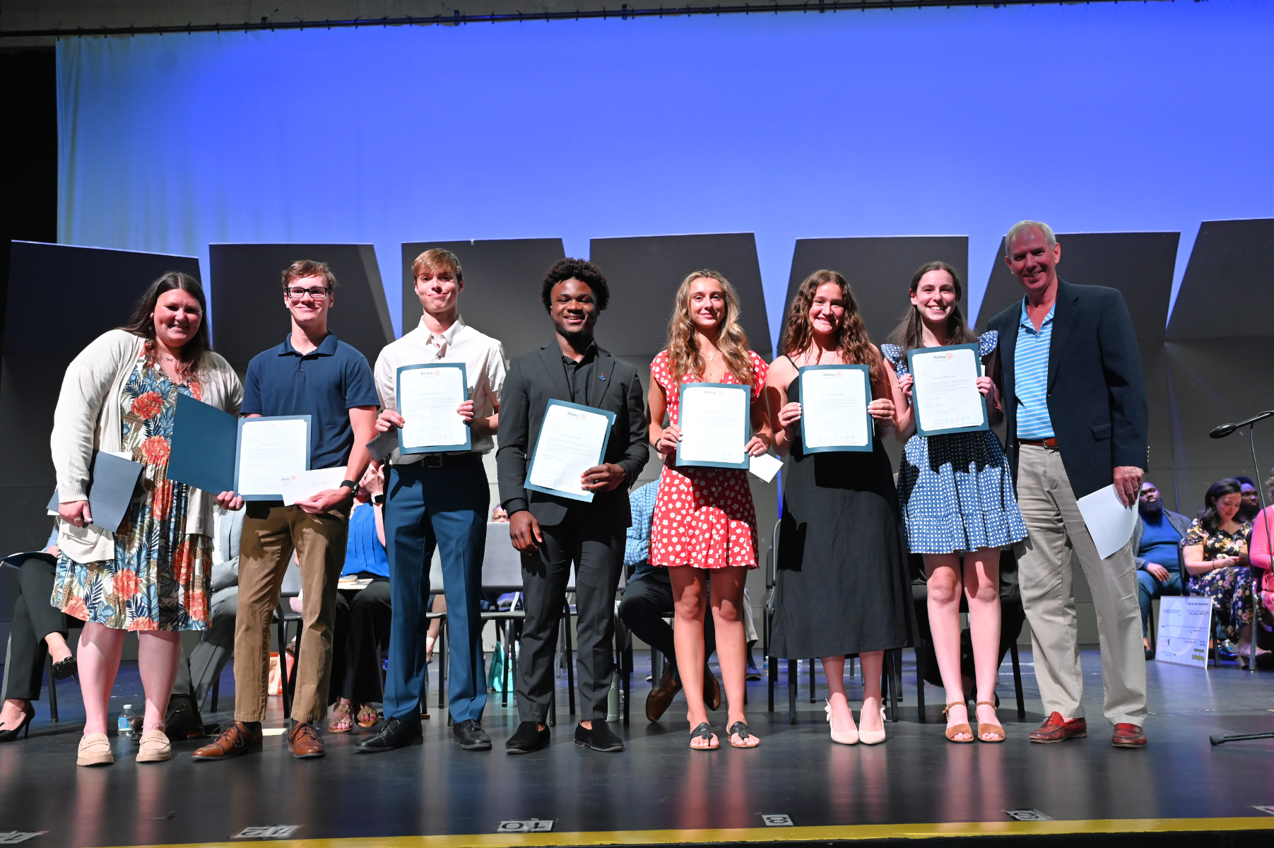  Rotary Club officials flank this year's scholarship recipients   