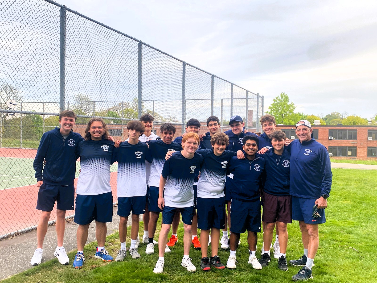  Coach Jamie Fishlow and the 2024 Huntington varsity boys' tennis team.   