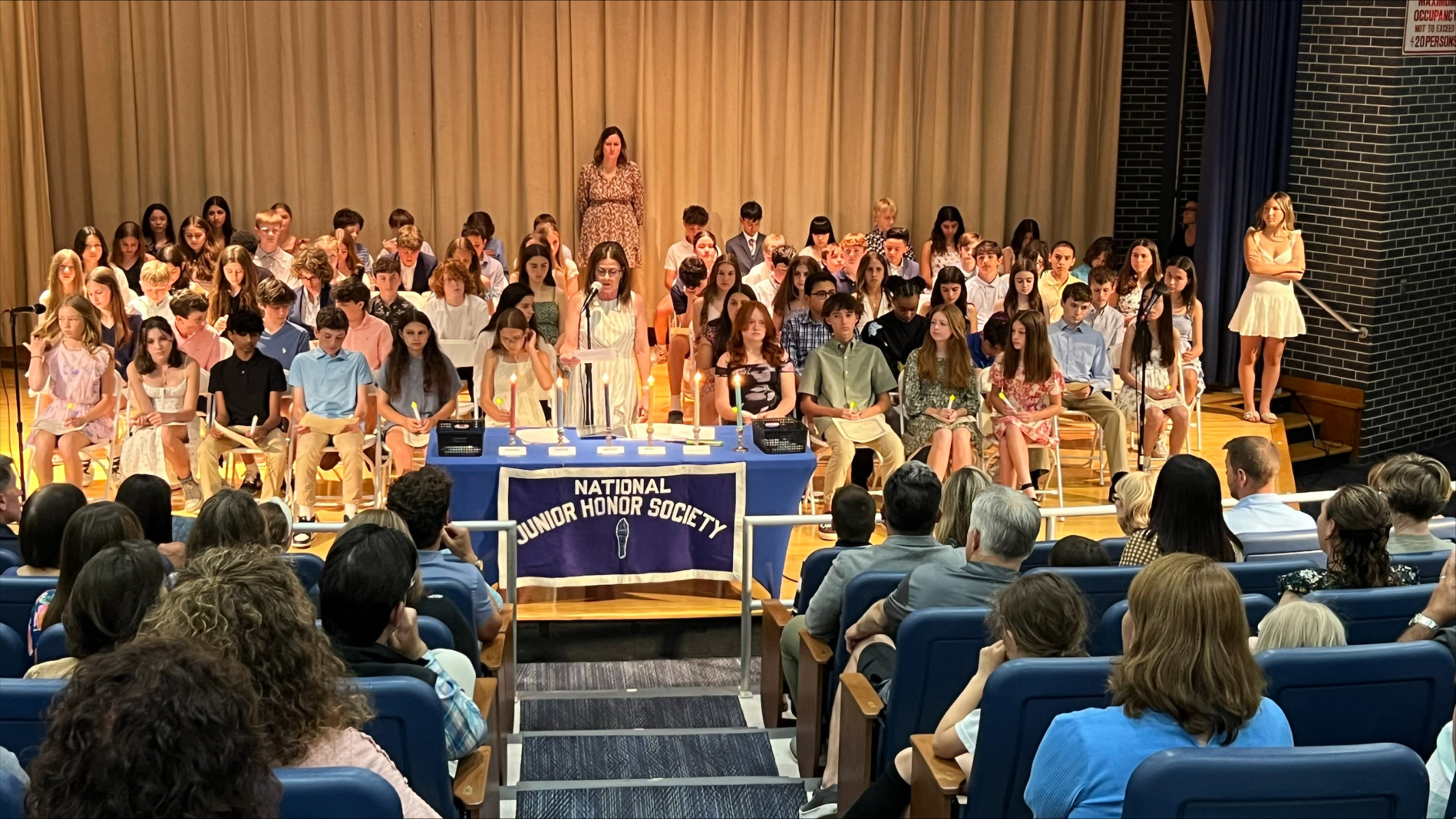  Principal Traci Roethel addresses the new inductees and their family members.   
