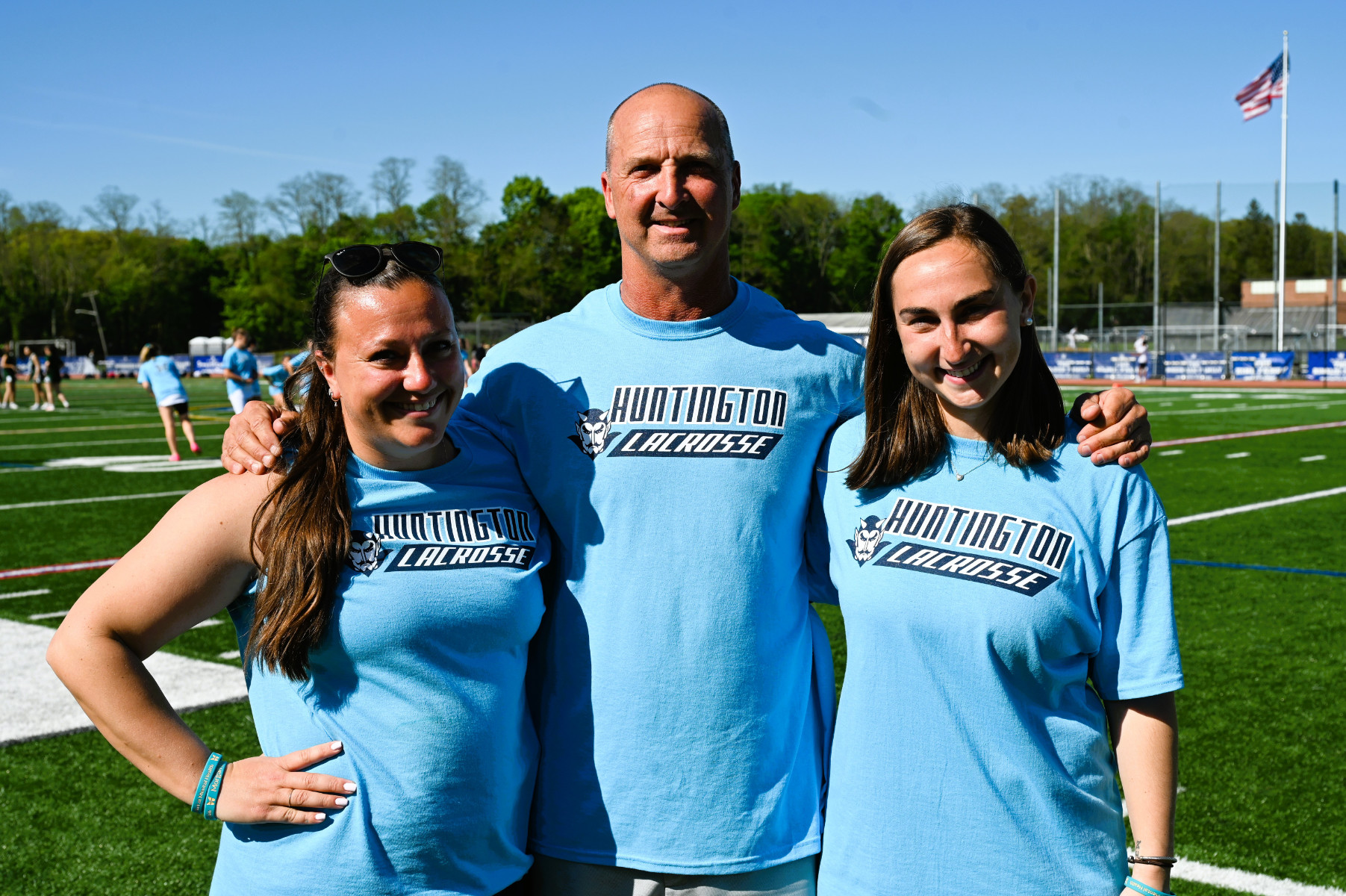 Huntington varsity girls' lacrosse coaches Lauren Blackburn, Chris Taylor and Katie Reilly
