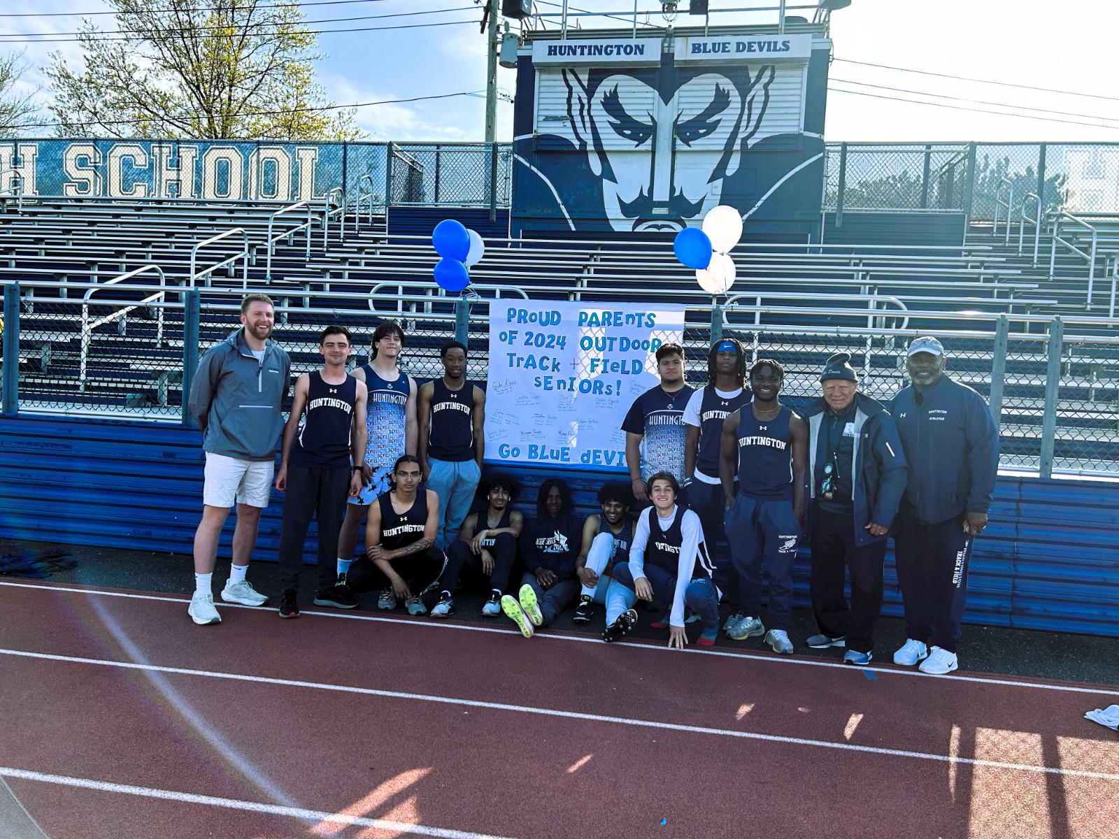 The Blue Devil boys' track seniors with their coaches on Senior Day.