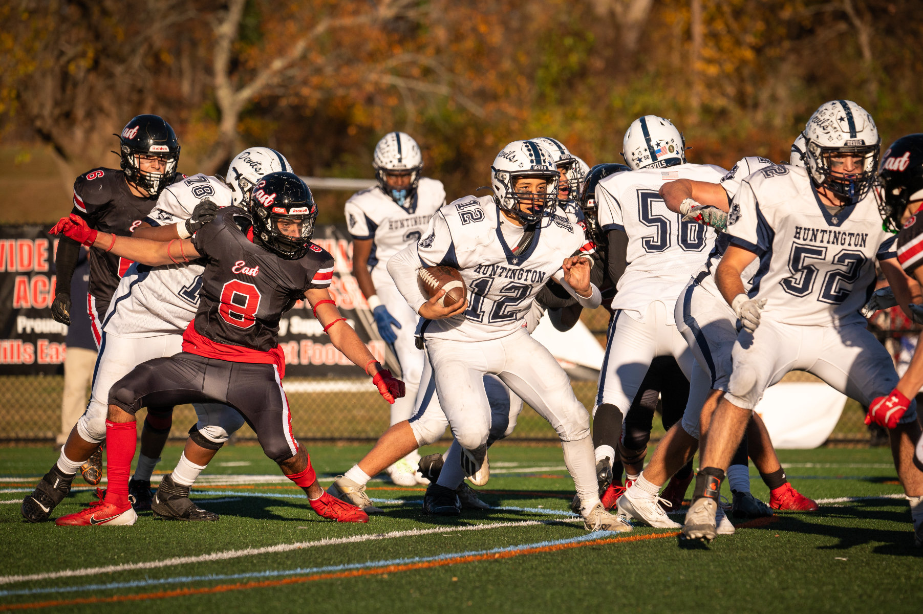 Quarterback Jacob Guzik is on the run in the playoffs at Half Hollow Hills East. (Darin Reed photo.)